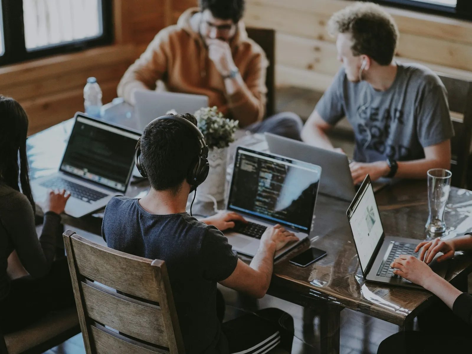 Engineers working together on laptops to build an AI solution