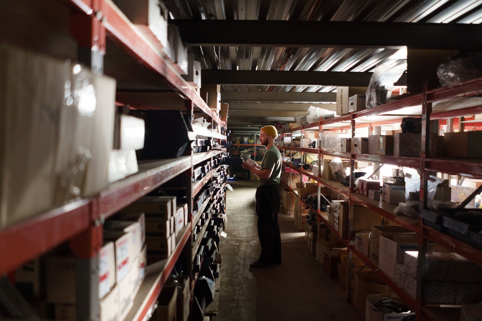 Warehouse operator checking stock the agents track across suppliers and shipping lanes