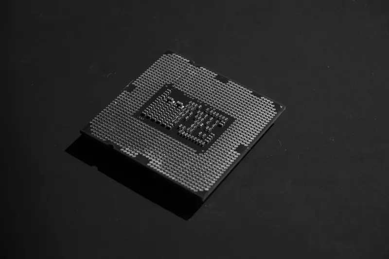 A processor chip lit against a dark background