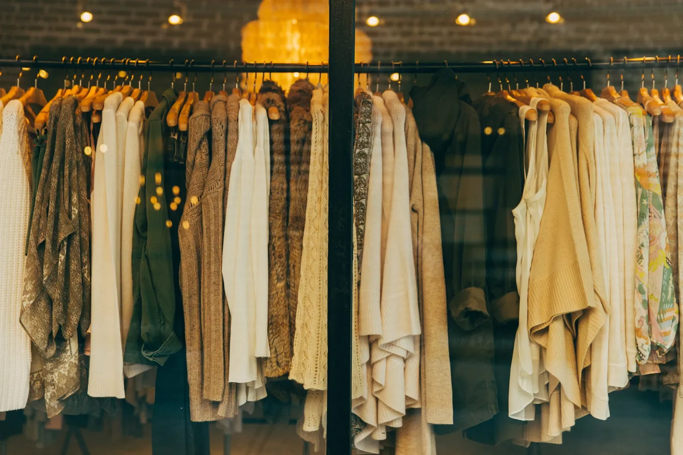 Rows of patterned shirts on wooden hangers in a clothing store