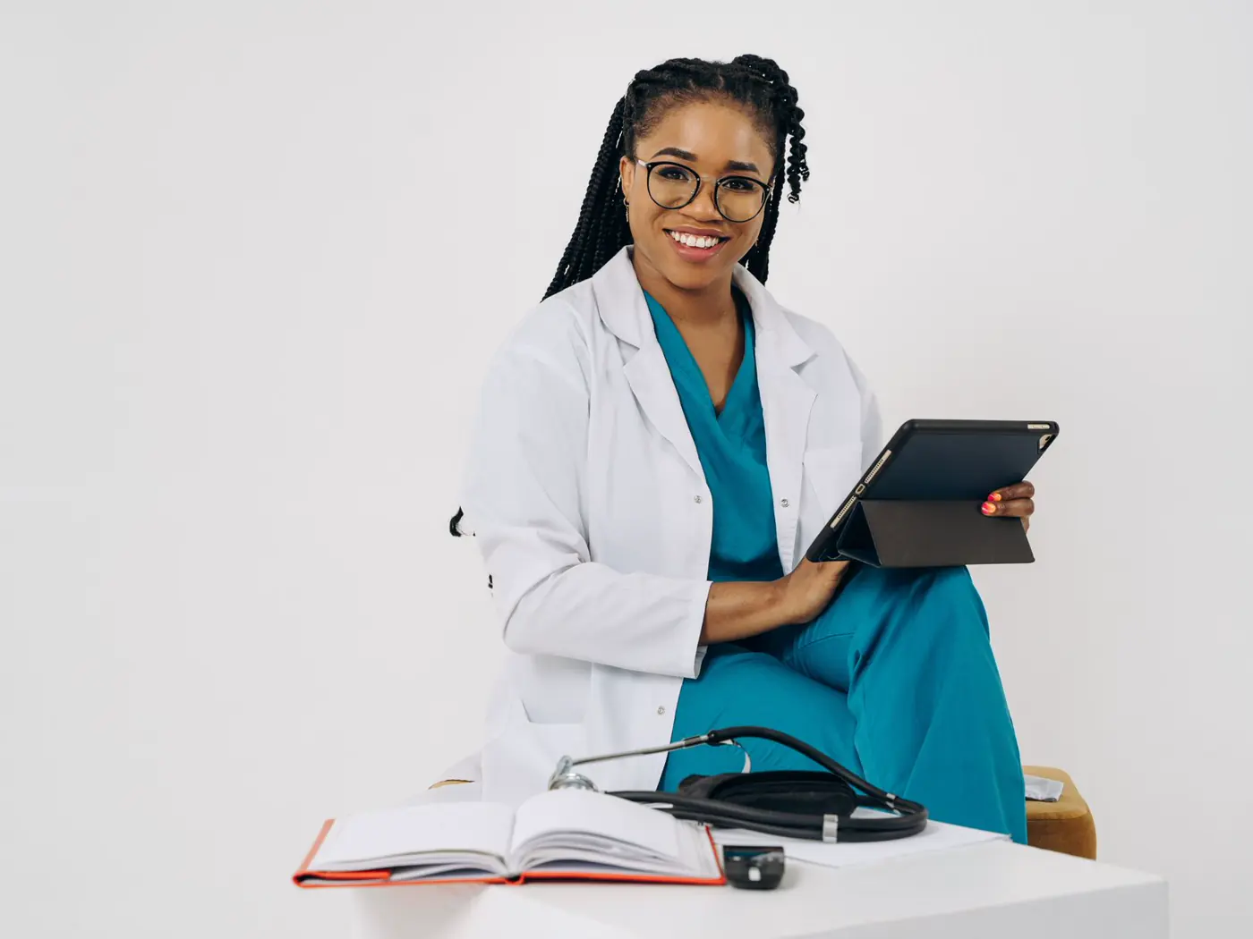 A clinician holding a tablet beside an open case notebook