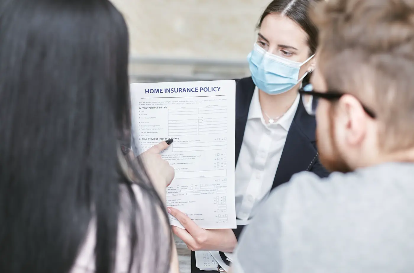 An insurance adviser walking a client through their policy schedule