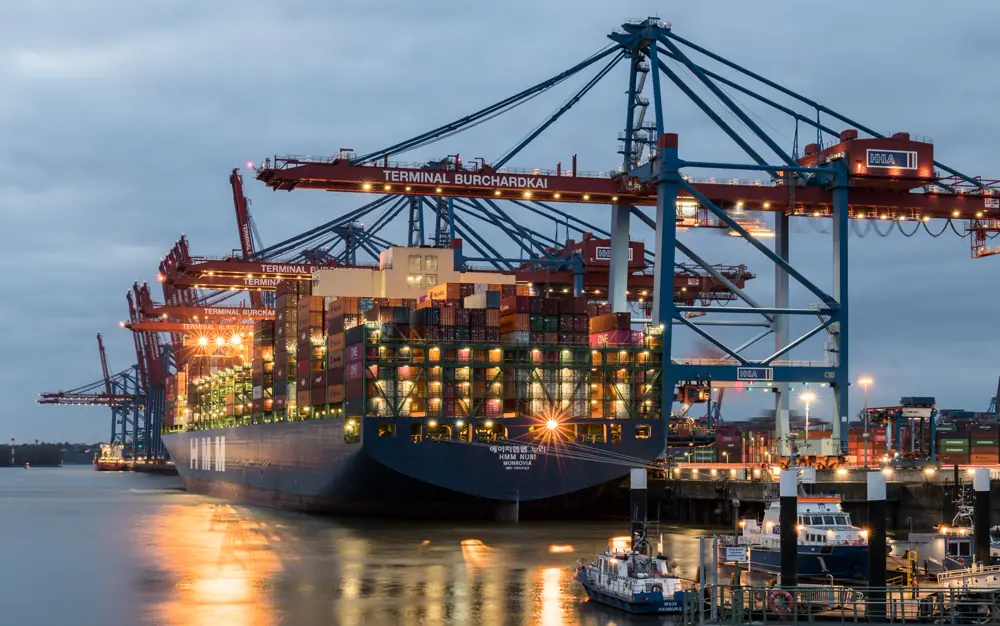 Container ships loading at a busy port