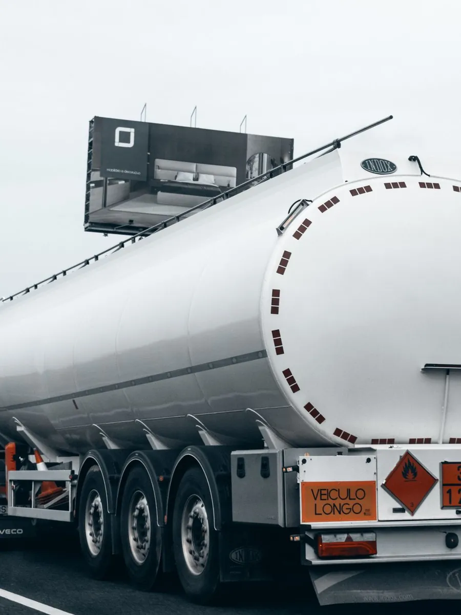 A stainless steel tanker trailer parked at a depot