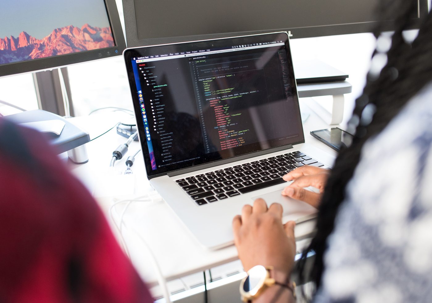 Developer writing model training code in an editor on a laptop