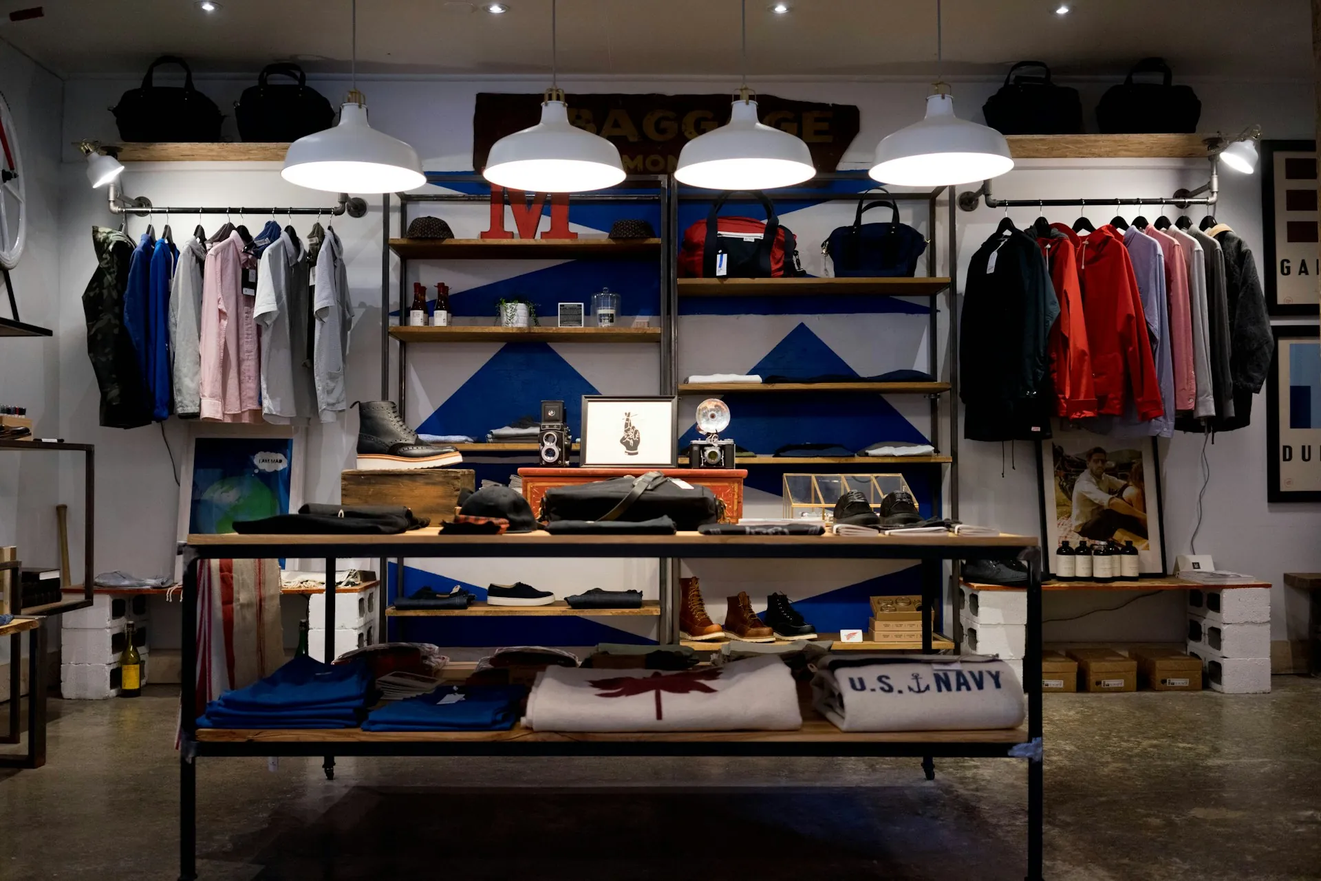 A modern retail store interior with folded garments on wooden shelving