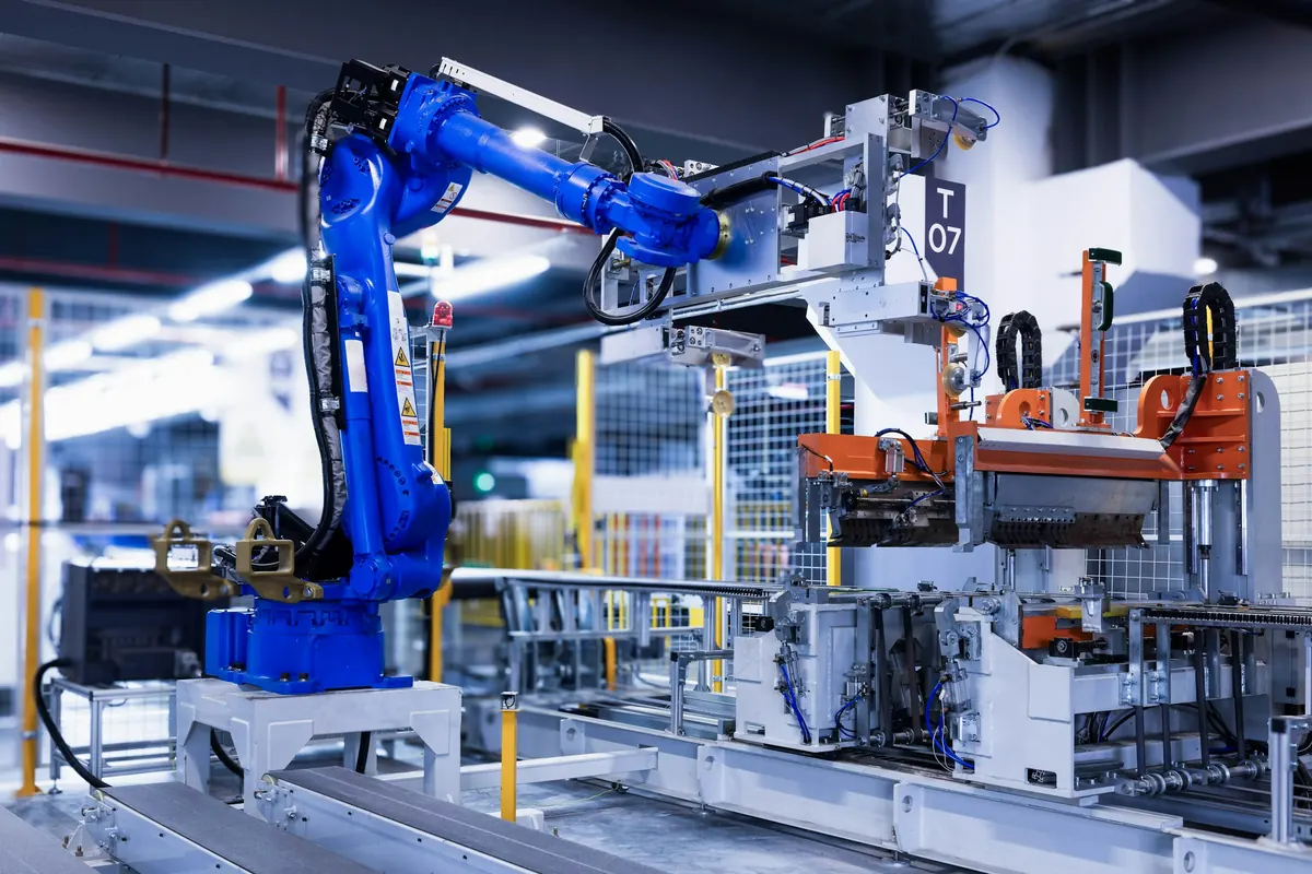 Blue industrial robot arm working on a production line