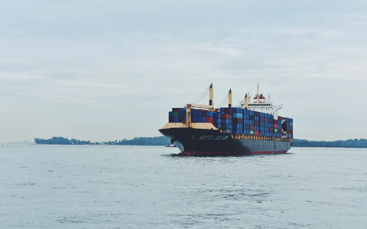 A loaded container ship under way on open water