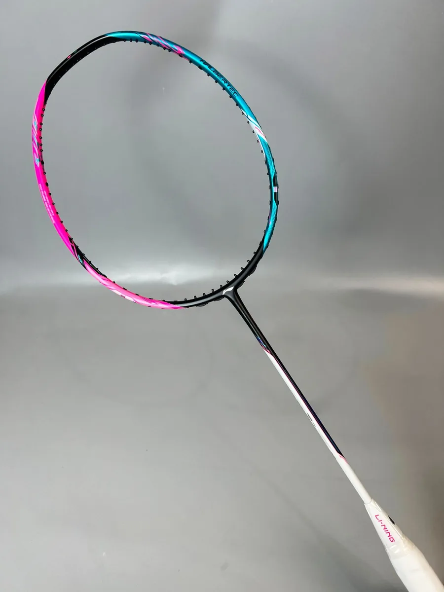 A badminton player striking a shuttlecock