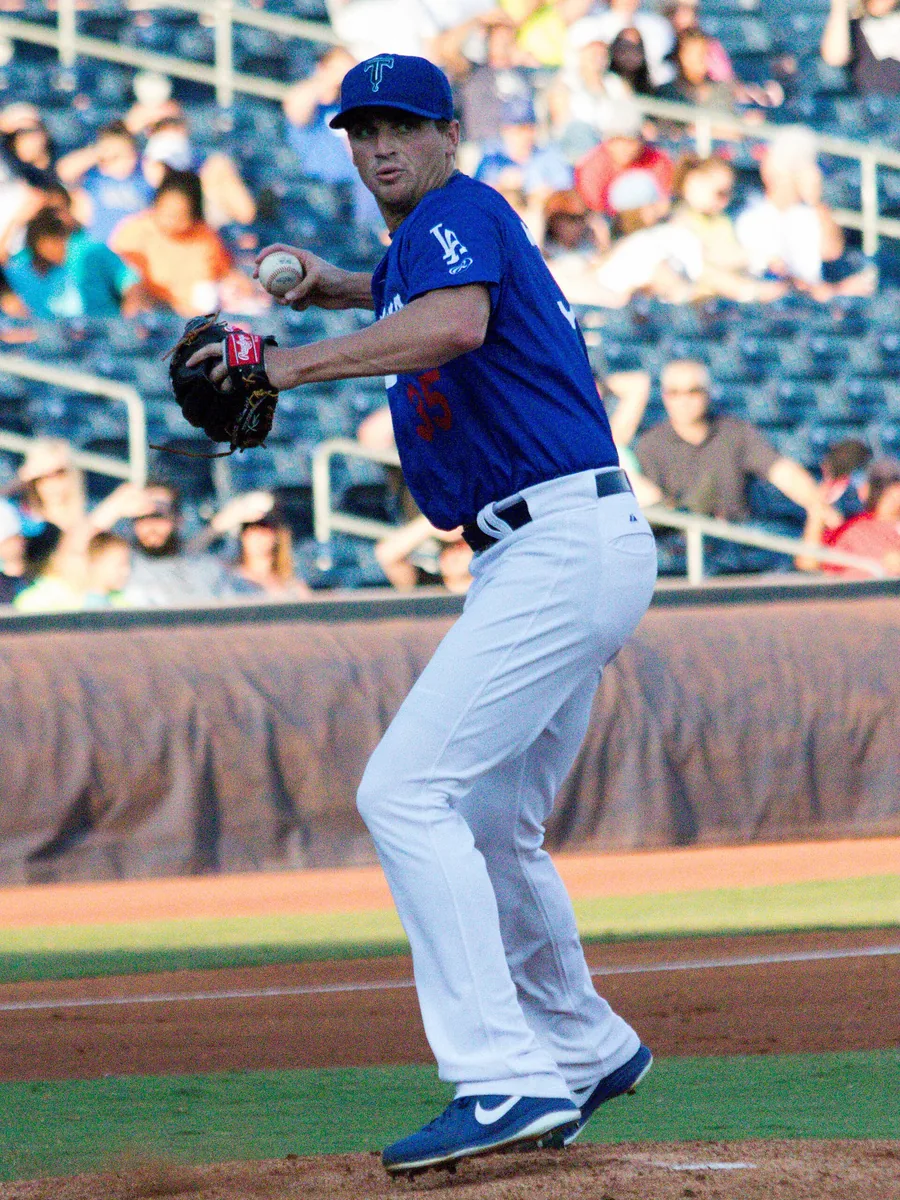 A pitcher mid-delivery on the mound