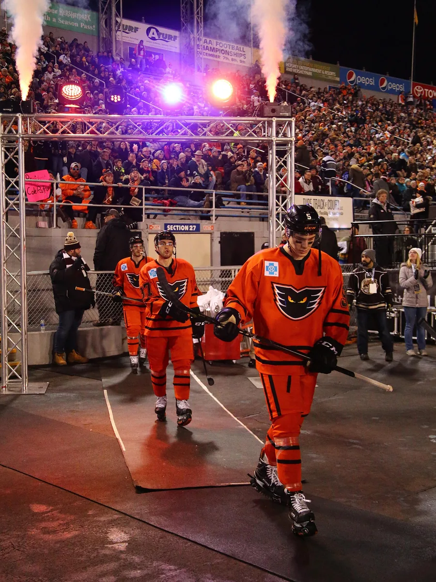 A hockey player driving forward with the puck
