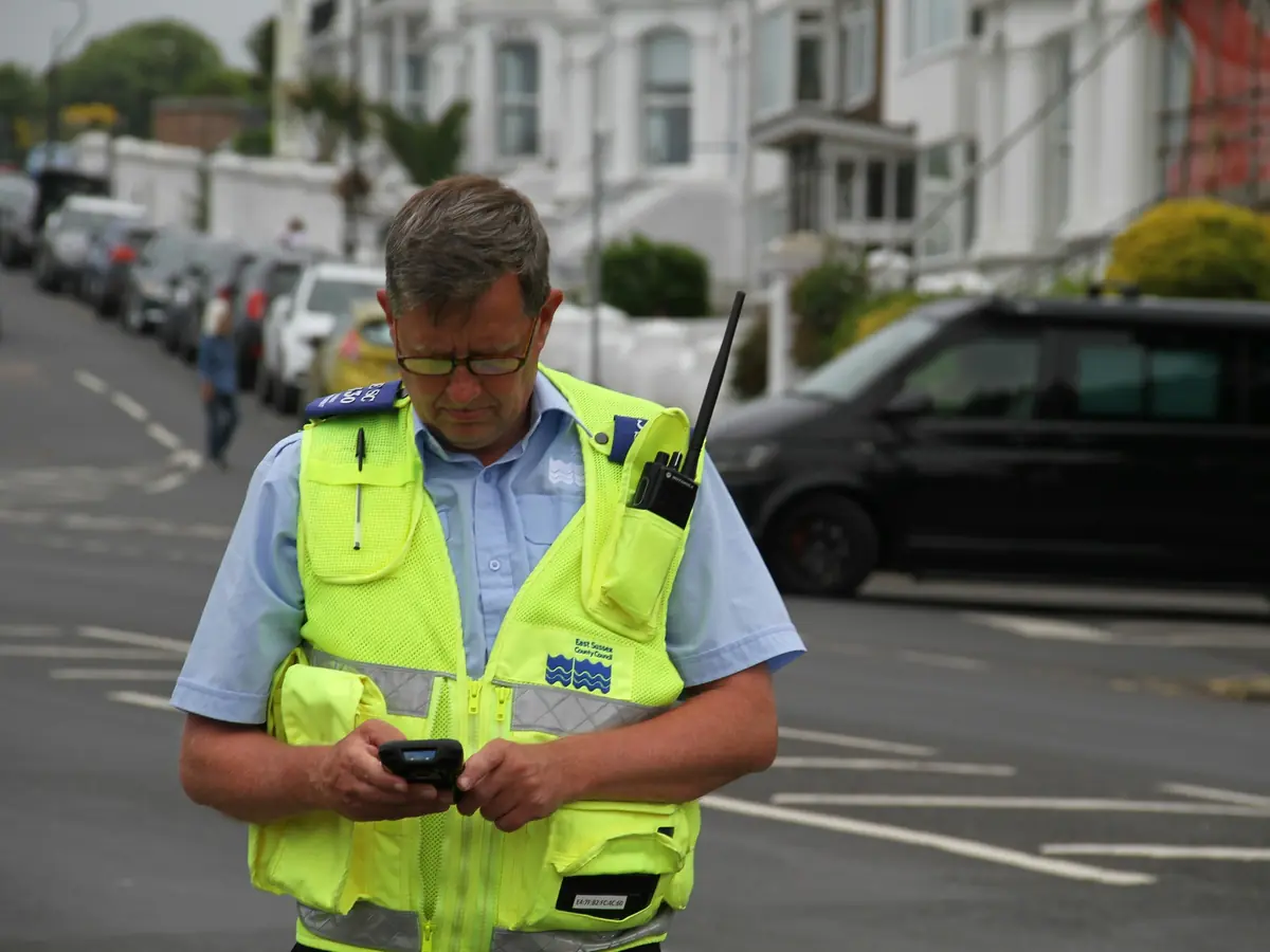 A logistics supervisor coordinating a yard by phone