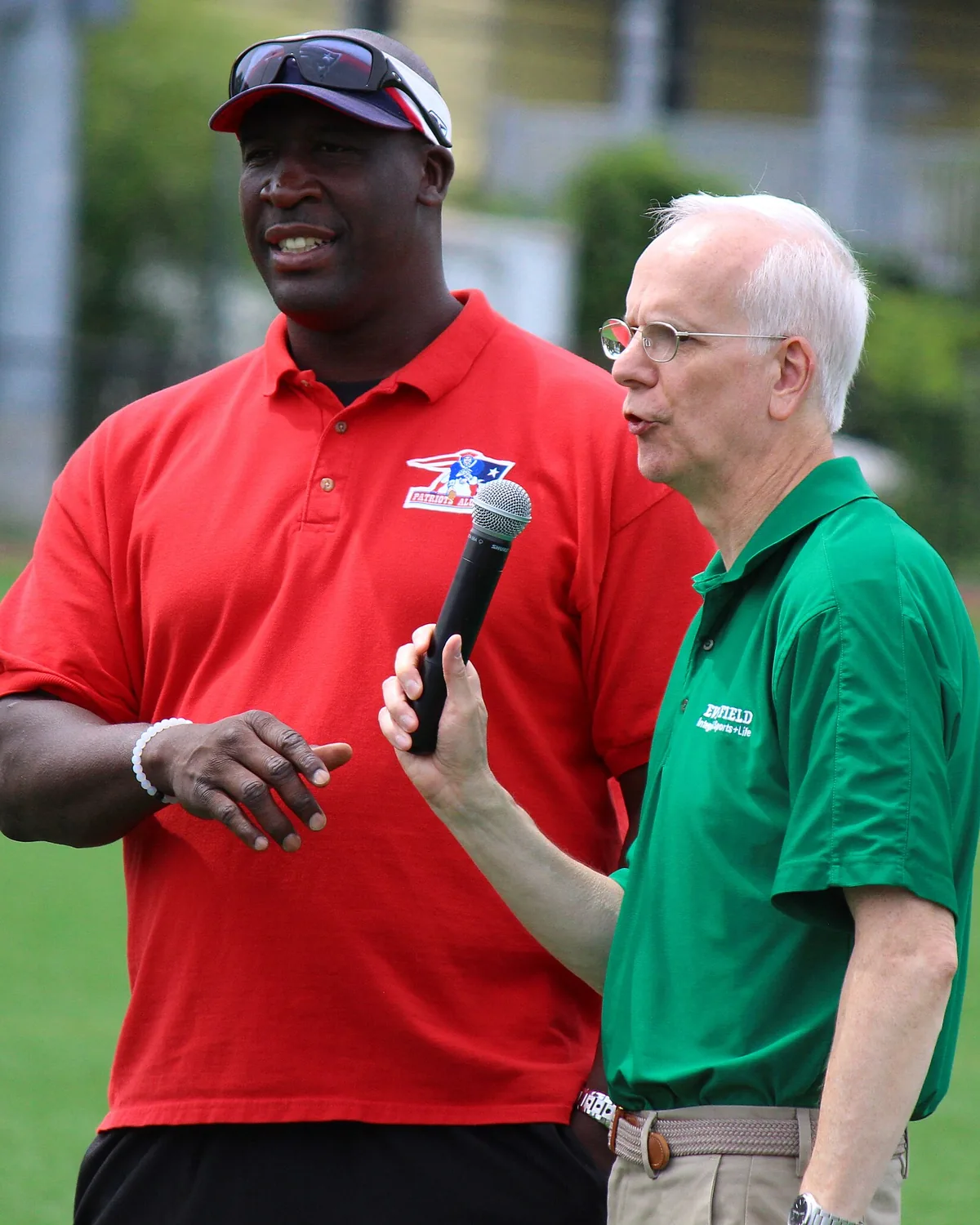 A reporter interviewing an athlete with a microphone