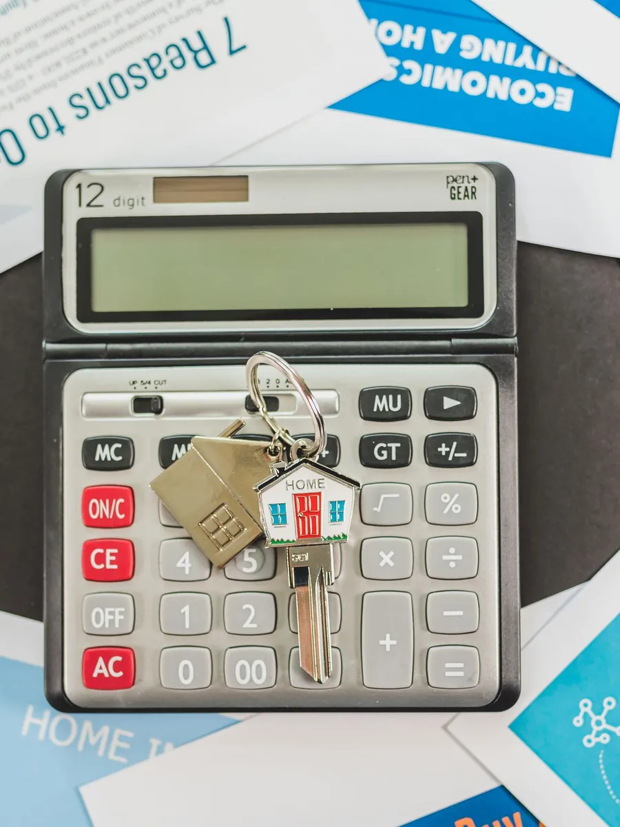 A calculator and keys resting on lending paperwork