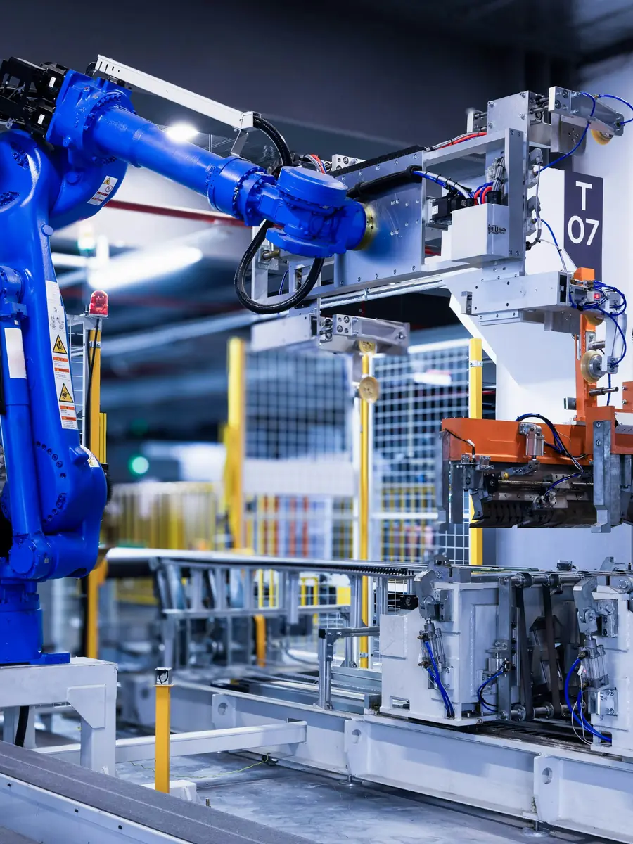 A robotic arm working a lit production line