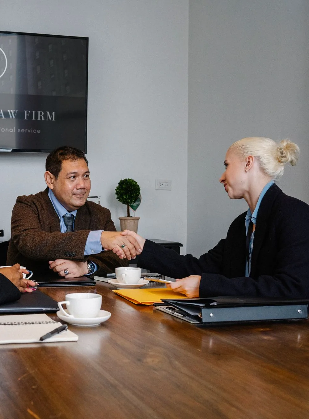 Legal service partners meeting across a desk
