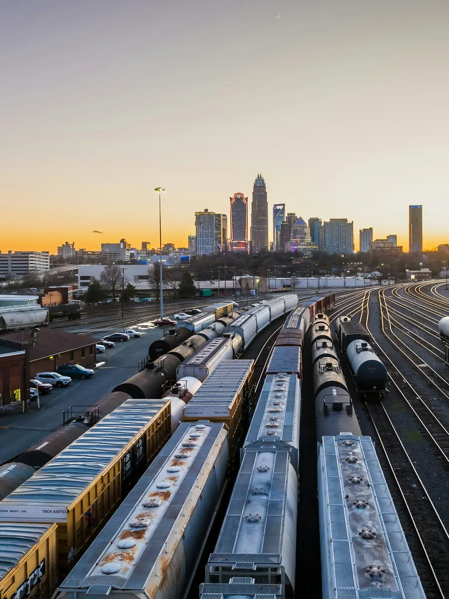 A freight train moving containers along a rail corridor