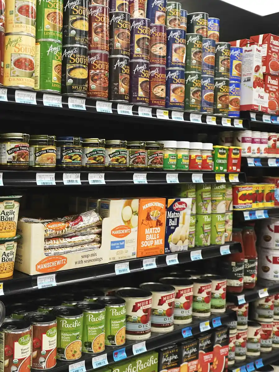 A retail team checking backroom stock against a device