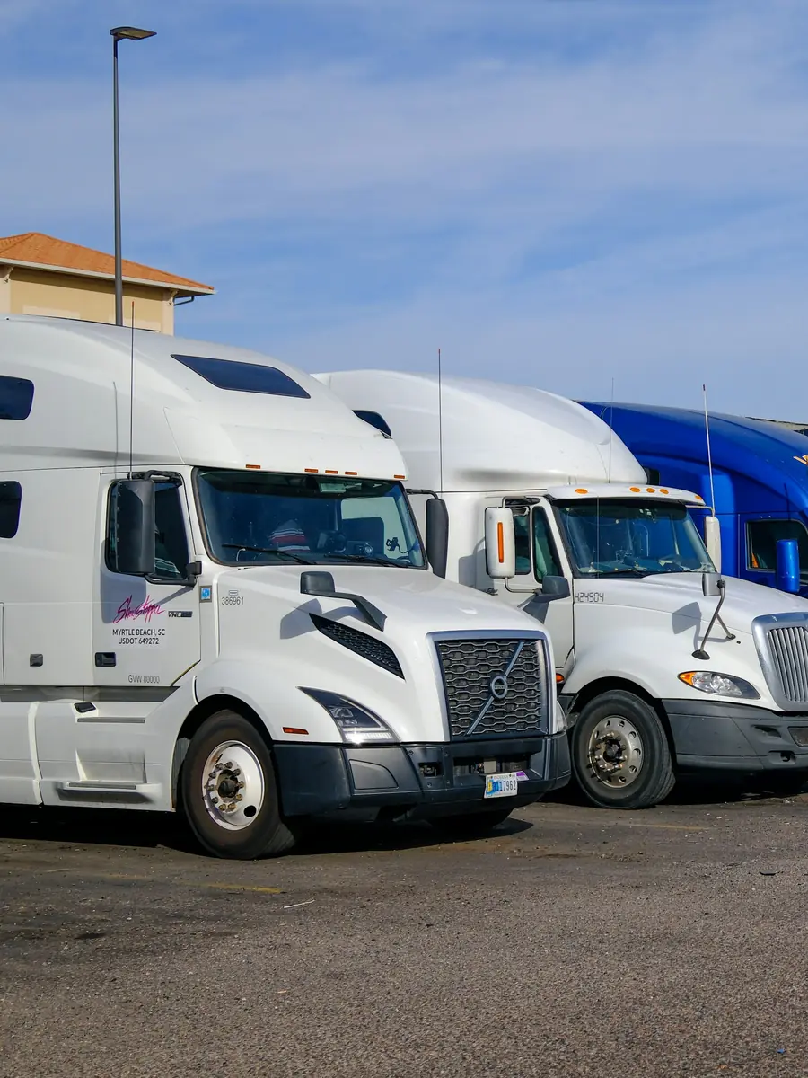 A freight fleet moving through a distribution hub at dusk