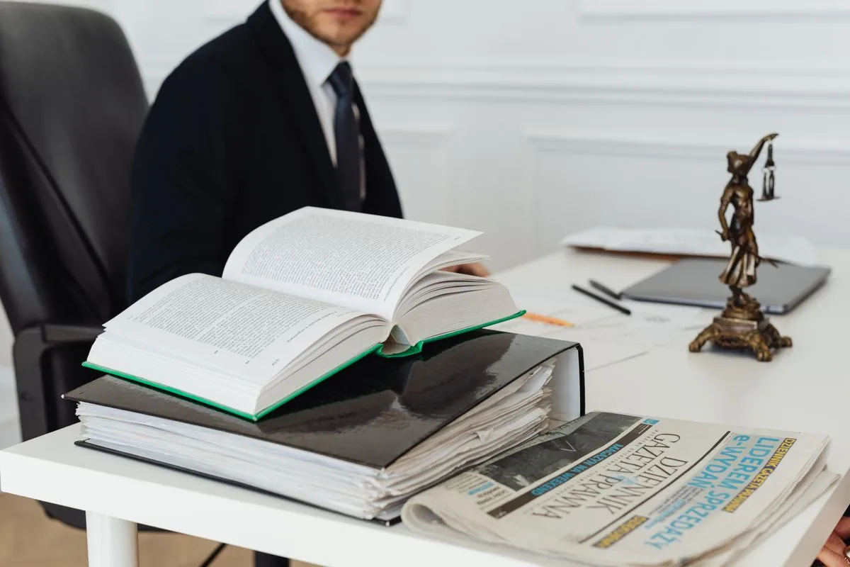 A casebook and binder open on a desk