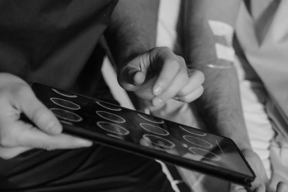 A doctor showing a CT scan to a patient on a tablet