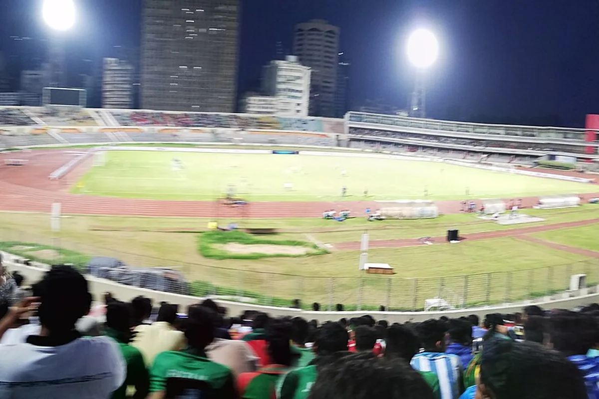A stadium stand packed with cheering spectators