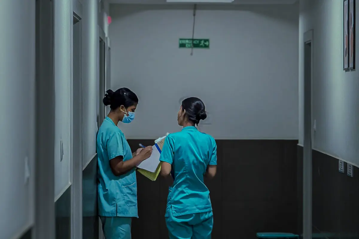 Healthcare professionals walking through a hospital corridor