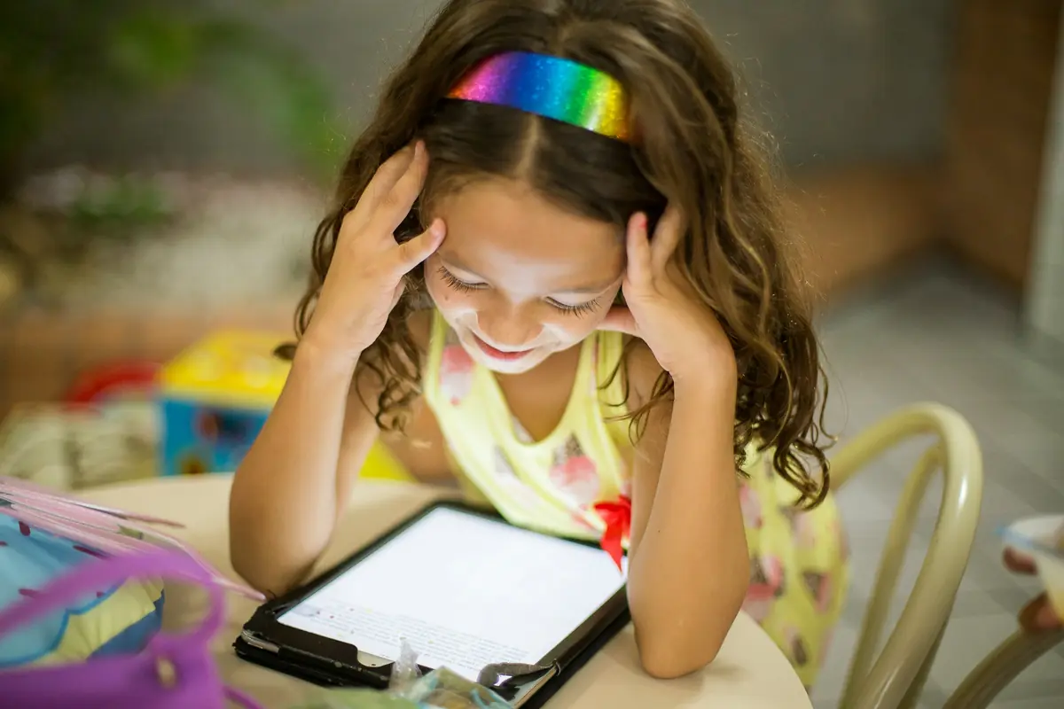A child following an interactive lesson on a tablet