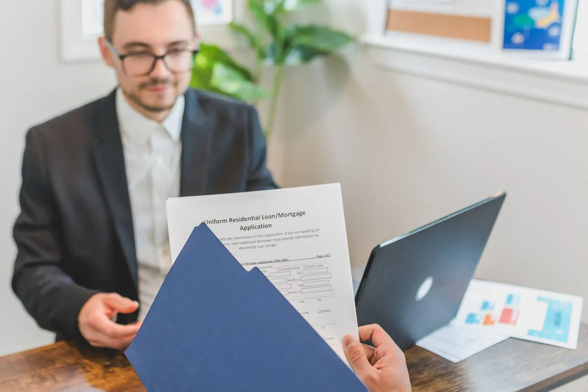 A lending adviser reviewing a loan application with a client