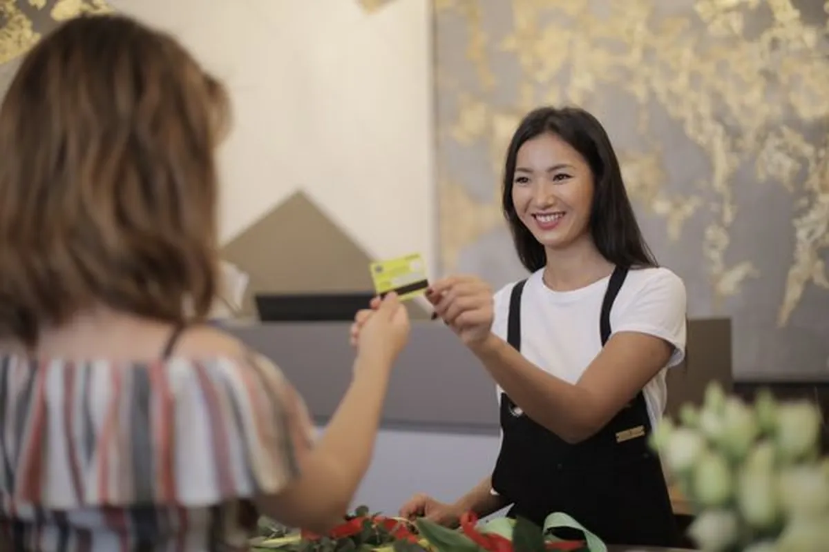 A customer redeeming a loyalty card at a shop counter