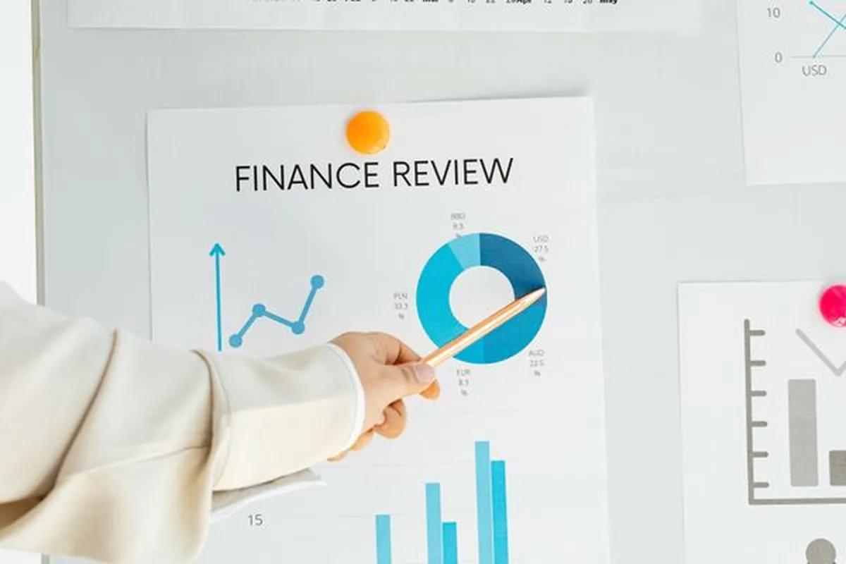 A finance review session with revenue charts on the table