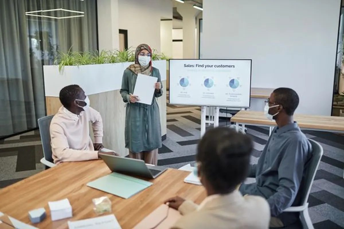 A sales team reviewing pipeline figures in a meeting room